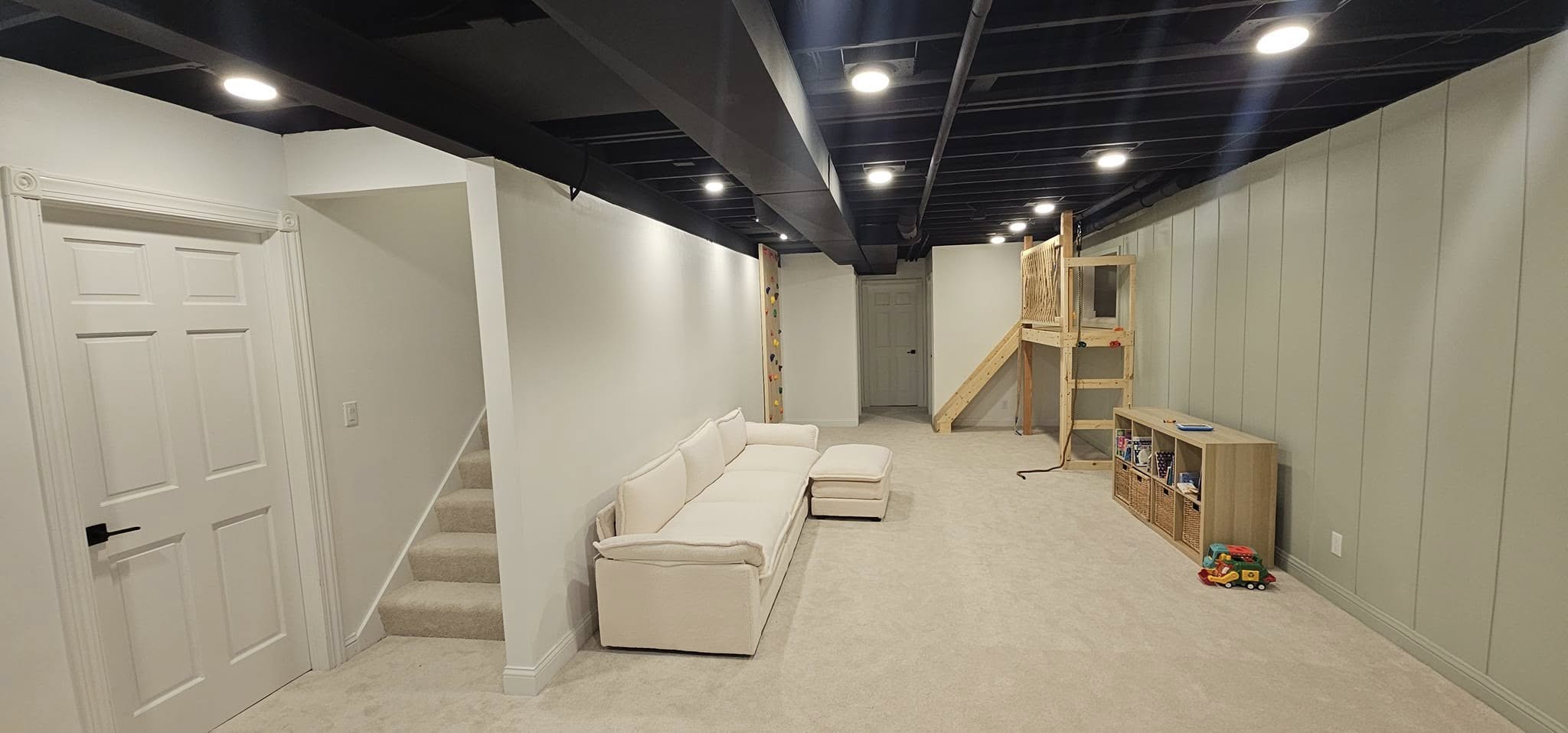 Basement remodel with beige carpet and new walls